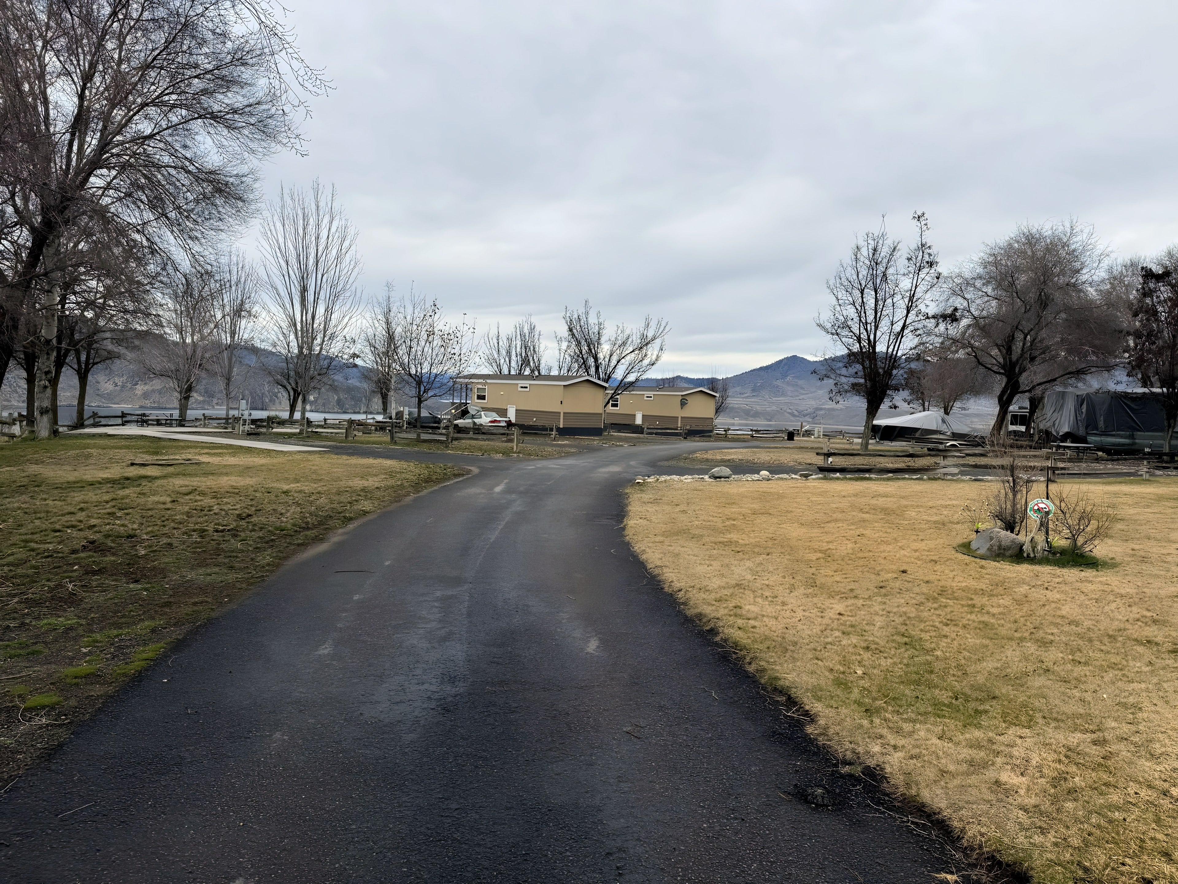 Paved road through grassy sites